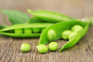 Fresh green peas on wooden table