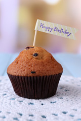 Blueberry muffins on color wooden table, on bright background