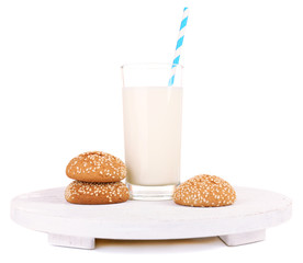 Milk and cookies on wooden tray isolated on white