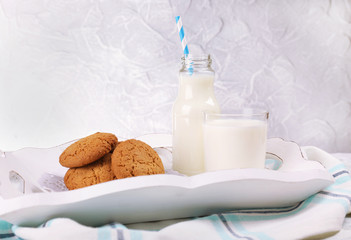 Milk and cookies on table on grey background