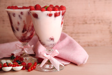Tasty raspberry dessert with berries on pink wooden background