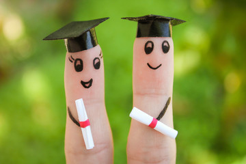 students holding their diploma after graduation