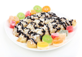 Sweetened fried banana on plate, isolated on white