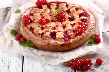 Tasty cake with berries on table close-up
