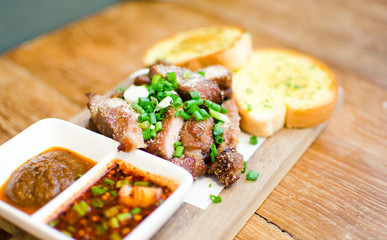 Slice Grilled pork with thai chilli sauce and garlic bread serve