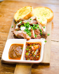 Slice Grilled pork with thai chilli sauce and garlic bread serve