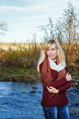 Lonely girl on bank of river