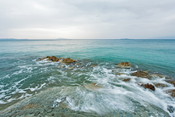 Beautiful rocky sea beach at the sunset