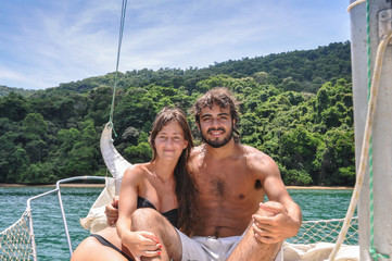 Cute Couple in love sailing through Paraty tropical islands. Bra