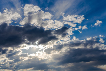Sky with sunshine and dark clouds.