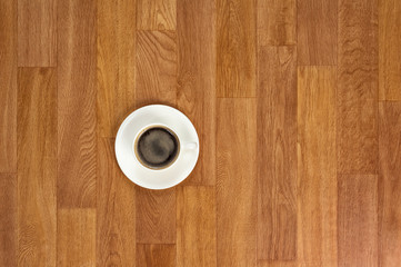 White cup of coffee on wooden table.