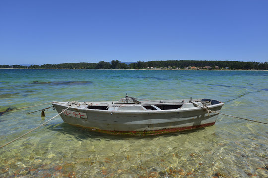 wooden colored boats in the beach sand