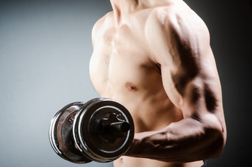 Muscular ripped bodybuilder with dumbbells