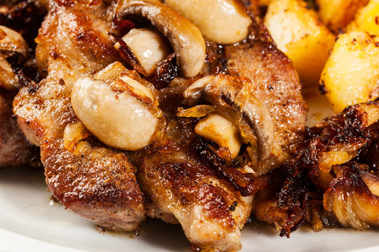 Closeup of roasted pork chop with mushrooms