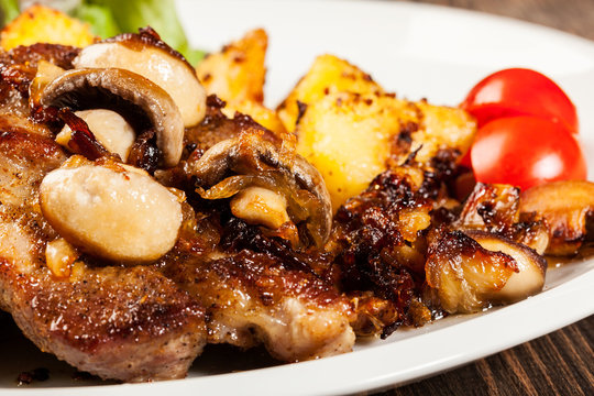 Fried pork chop with mushrooms and chips