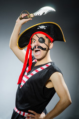 Funny pirate in the dark studio