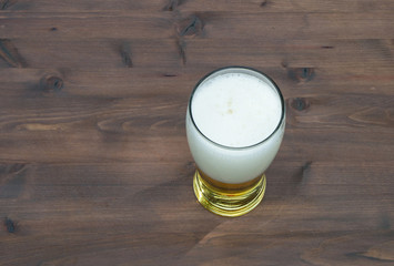 glass with beer on old wooden table