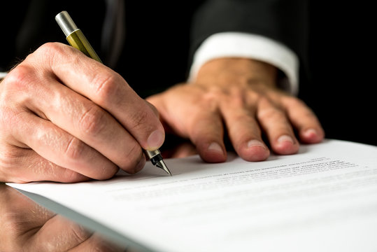 Man signing a typed document