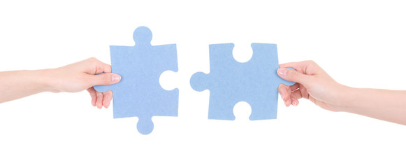 two puzzle pieces in woman hands isolated on white