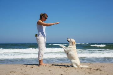 Woman learner dog on the beach