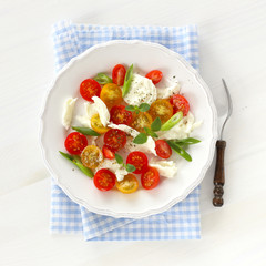 Mozzarella with red and yellow cherry tomatoes