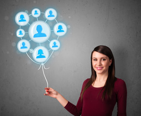 Woman holding social network balloon