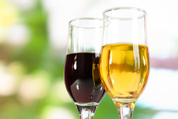 Wine in glasses on nature background