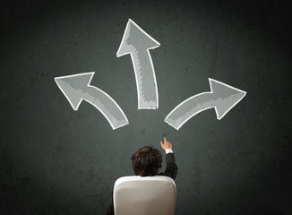 Businessman deciding with arrows above his head