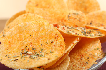 Homemade potato chips in glass bowl, close up