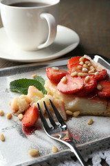 Piece of strawberry tart on  tray, on rustic wooden background