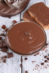 Sweet chocolate cream in bowl on table close-up