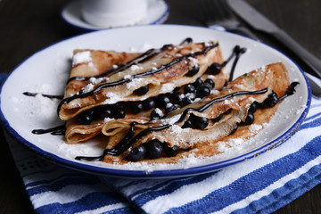 Delicious pancakes with blueberries on table close-up