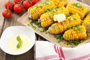 Grilled corn cobs on table, close-up