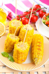 Grilled corn cobs on table, close-up