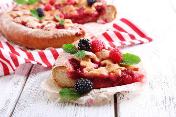 Tasty cake with berries on table close-up