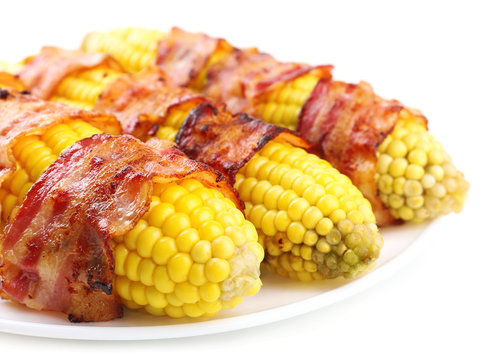 Grilled bacon wrapped corn, isolated on white