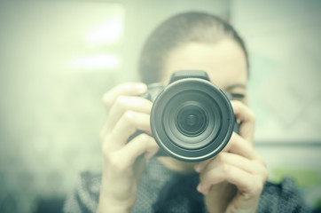 Young smiling girl making photo