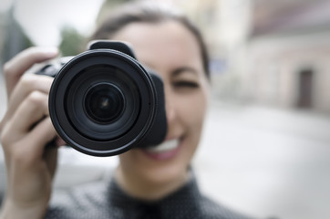 Young smiling girl making photo