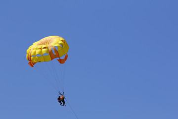 Parasailing against blue sky