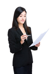 Asian business woman look at information on paper