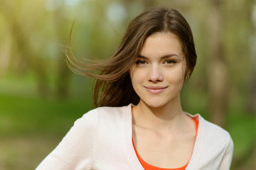 Naklejka premium beautiful young woman in park