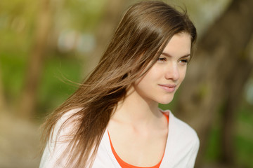 Fototapeta premium beautiful young woman in park looking to the side