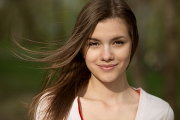 Naklejka premium beautiful young woman in park