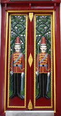 Wooden door is in temple Thailand.And carving is sentry.