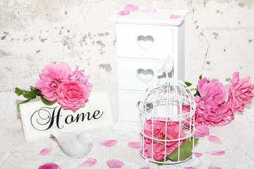 Bird cage filled with roses