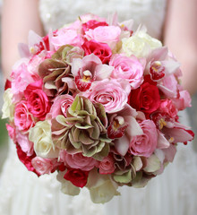 Beautiful wedding bouquet in hands of the bride