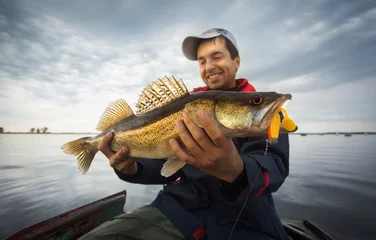 Foto op Plexiglas Happy angler with zander fishing trophy © vitaliy_melnik