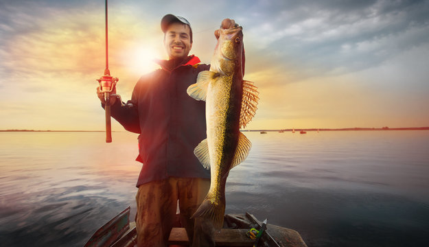 Happy angler with zander fishing trophy