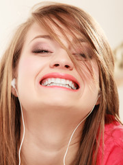 Girl with white headphones listening to music