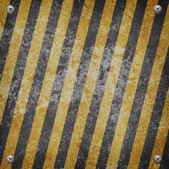Industrial grungy steel plate with black and yellow strip